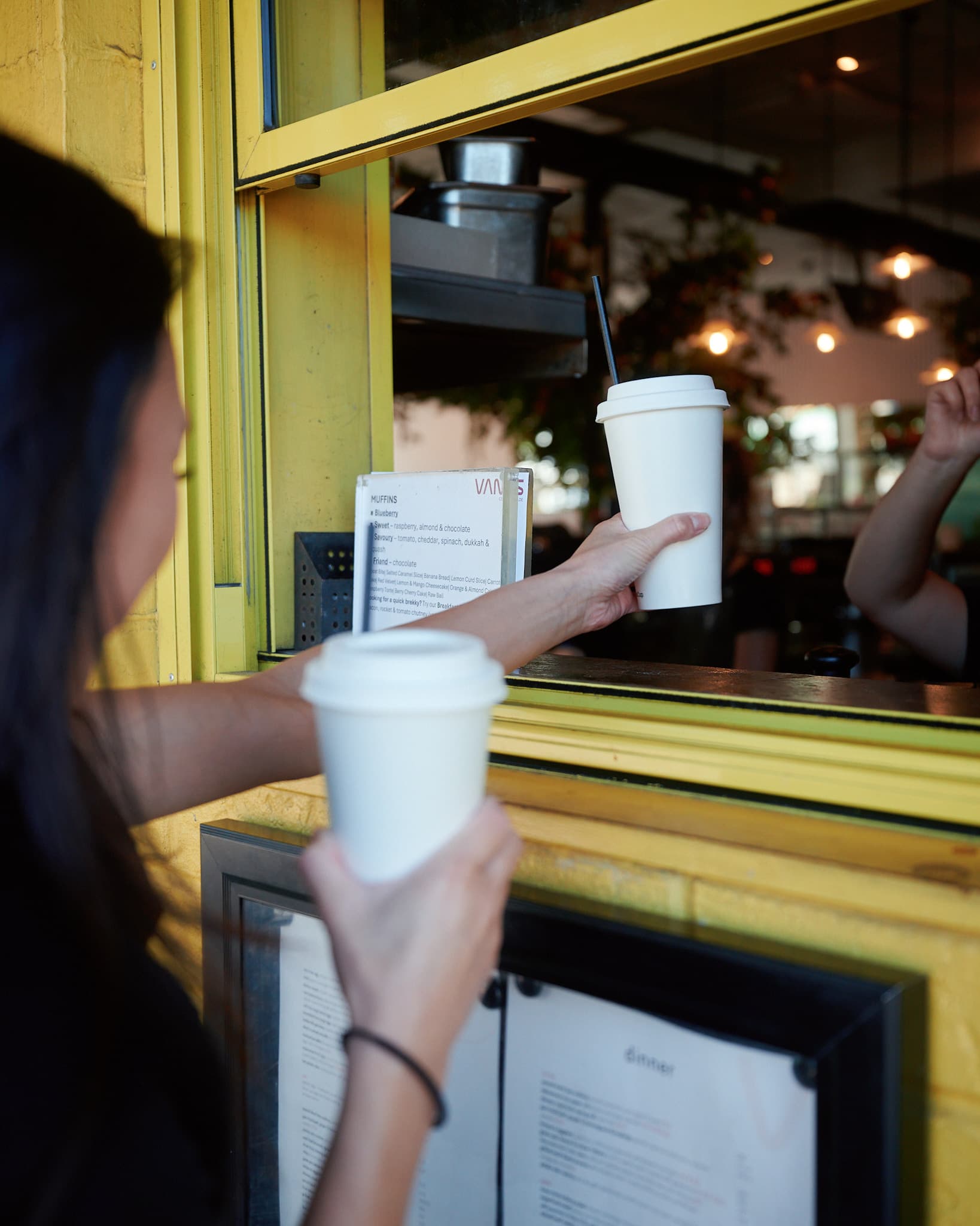 Handing over coffee at a Perth cafe window