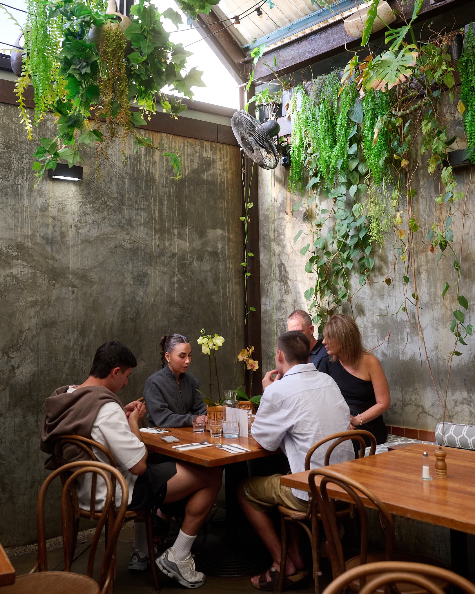Diners at a leafy Perth venue courtyard